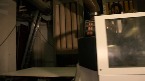 Two men are working at the machine. Processing of wooden structures for the cabi Stock Footage 125427624