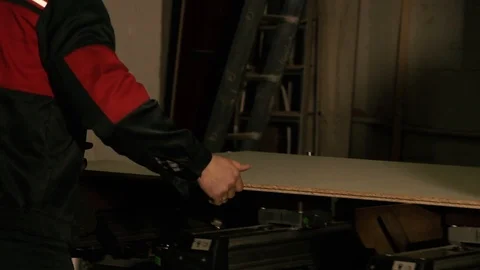 Two men are working at the machine. Processing of wooden structures for the cabi Stock Footage 125427693