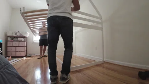 Two men assembling a loft bed in a child's room Stock Footage 296305164