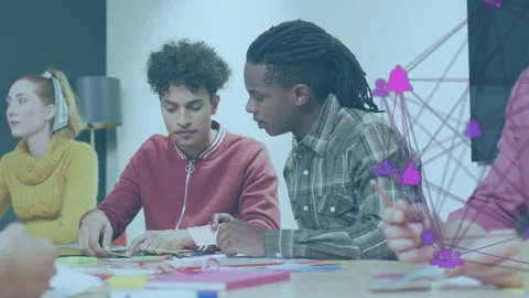 Two men assembling paper after design prompt, aligning cutouts as purple network Stock Footage 333477674