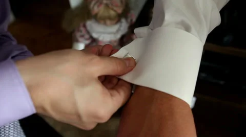 Two men attaching cuff links a moment before wedding Stock Footage 37255377