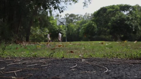 Two Men In Background Playing Basketball in Park 스톡 동영상 188332761