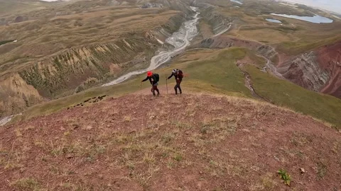 Two men with backpacks climb the mountain. Mountain landscape Video stock 208437991