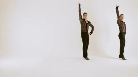 Two men, ballet dancers, dancing in the studio on a white background. Video stock 91000428