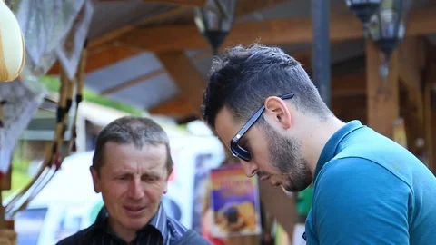 Two men bargaining on the market Stock Footage 95898795