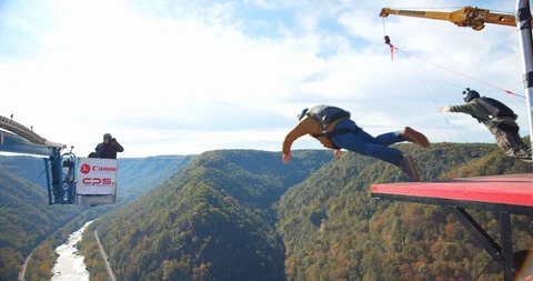 Two Men Base Jumping Off Bridge With Parachute, Slow Motion Backflip Stock Footage 127466846