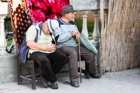  Two men in a bench in Romania Stock Photos