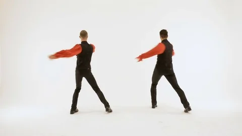 Two men in black suits dancing on a white background. Video stock 81324915