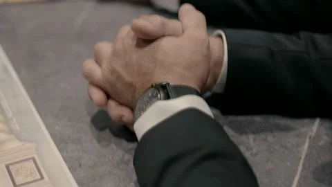 Two men in black suits put their hands on the table in a meeting. Stock Footage 226786688
