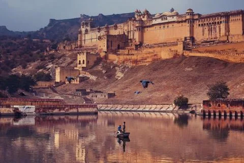 Two men on the boat is floating near Amber Fort in India, Jaipur, Rajasthan s Stock Photos