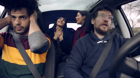 Two men bored of women talking in car Stock Footage 57713731