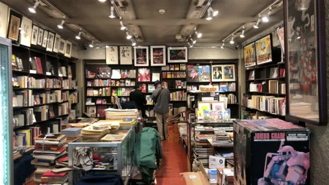 Two men browsing at a book store in Chiyoda City Stock Footage 131440737