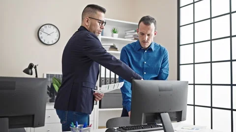 Two men business workers using computer reading document at office Stock Footage 243486970