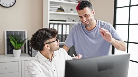 Two men business workers using computer high five at office Stock Footage 245556746