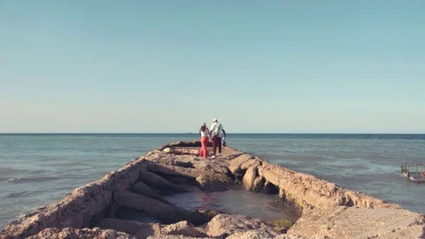 Two men came on a broken pier. Stock Footage 72488333