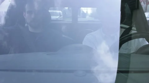 Two men in car driving through the neighbourhood Stock Footage 41496532