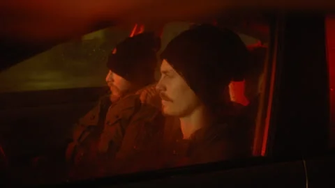 Two men in a car pulling down ski masks over their faces Stock Footage 275168526