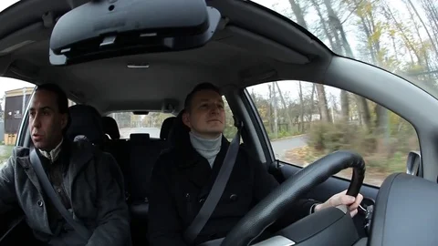 Two men in car, quickly ride at city outskirts, autumn season Stock Footage