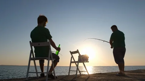 Two men catch fish in the sea 動画素材 123953863