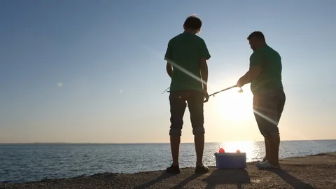 Two men catch fish in the sea Stockbeeldmateriaal 123953901