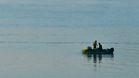 Two men catching fish from boat. Stock Footage 67954395