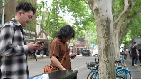 Two men checking smartphones on sidewalk Stock Footage 346302397