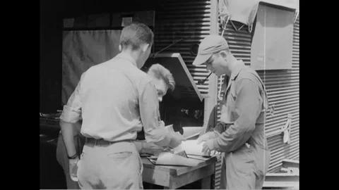 Two men checks the photograph printed from lab and sent further to Wing-A2- 1944 Stock Footage 99786453