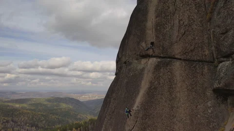 Two men climb a vertical rock wall. Mountaineering partner insurance. Stock-Footage 121915475