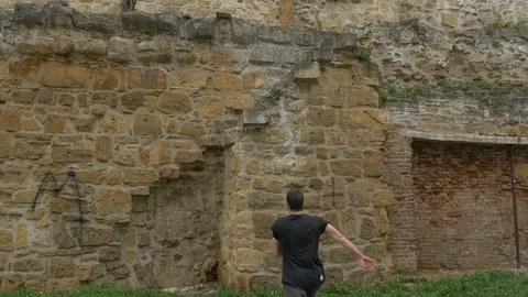 Two men climbing a stone wall Stock Footage 87399186