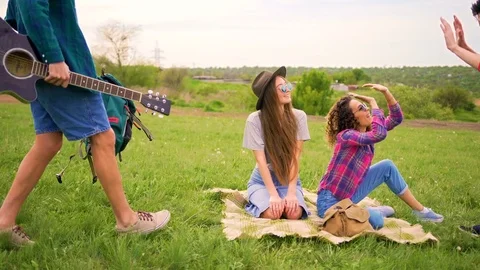 Two men comes to two beautiful girls at the park.  Stock Footage 75694308
