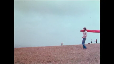 Two men compiling glider on hill with audience, United Kingdom, 1979 Stock Footage 136678039