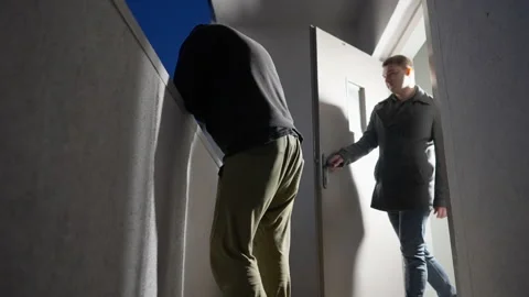 Two men completing a transaction in an open doorway Stock Footage 166217823