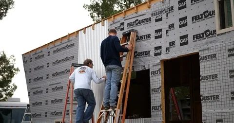 Two men construction workers building a tiny house for alternative living. Video stock 120755570