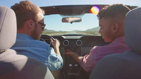 Two Men In Convertible Car Driving Along Road Shot On R3D Stock Footage 60032506