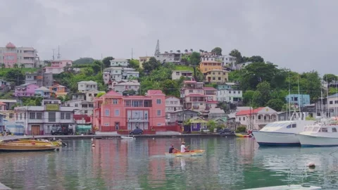 Two men crossing The Carenage harbor in a small boat Stock Footage 313406971