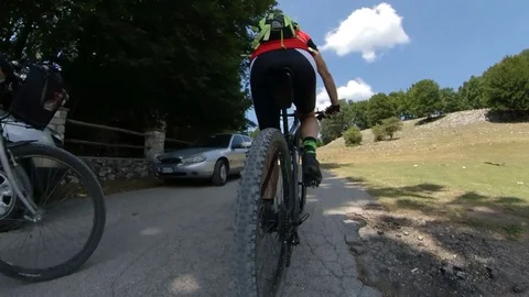 Two men cyclists ride on a mountain road, vr360 effect Stock Footage 113056183