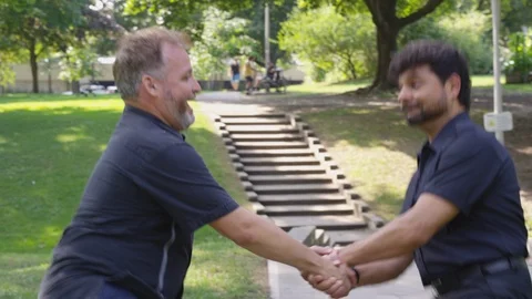 Two men dance with each other at the park on a sunny day - shot on RED Stock Footage 124718598