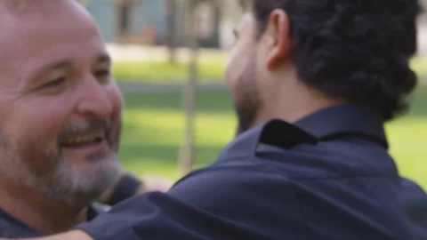 Two men dance with each other playfully at the park - slow motion - shot on RED Stock Footage 124909970