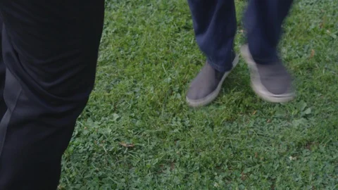 Two men dance with each other playfully at the park - slow motion - shot on RED Stock Footage 124910650