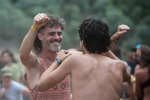 Two men dance on the main stage of the psytrance Lost Theory festival in Riomalo Stock Photos