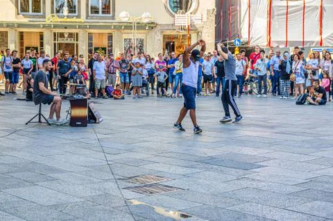 Two men dancing breakdance and perform acrobatic moves stunts on asphalt Stock Photos