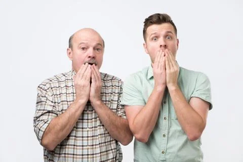 Two men of different generation have uexpected gaze at camera can not believe Stock Photos