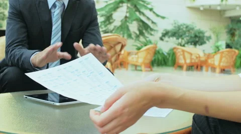 Two men discuss financial counting of the colleague Stock Footage 57457661