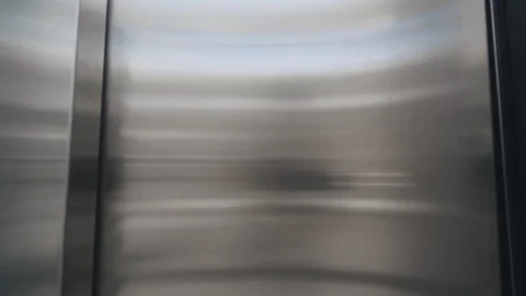 Two men in disposable masks exiting elevator 스톡 동영상 126782021