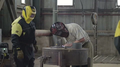 Two men do welding indoor distant plan Stock Footage 88063491