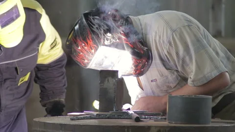 Two men do welding indoor close-up Stock Footage 88100926