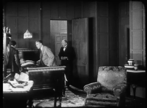 Two men doctors rushing to help old man laying in bed, United Kingdom, 1923 Stock Footage 172219620