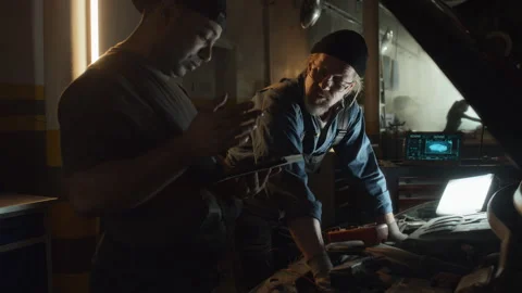 Two Men Doing Car Diagnostics In Repair Shop Stock Footage 244831211