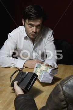Two men doing a shady business deal Stock Photos