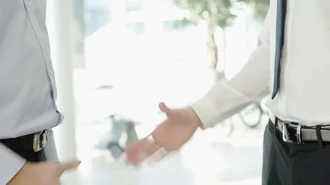 Two men dressed in a strict attire shaking hands with each other Stock Footage 73286159